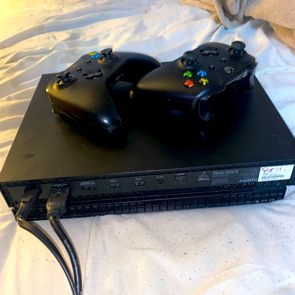 Xbox One X with controllers and cords